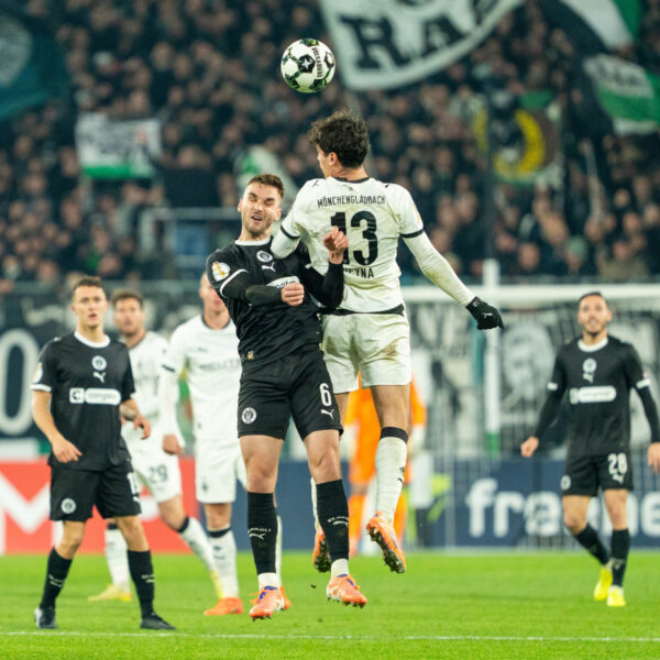 Gladbach player James Sands challenging for a header.